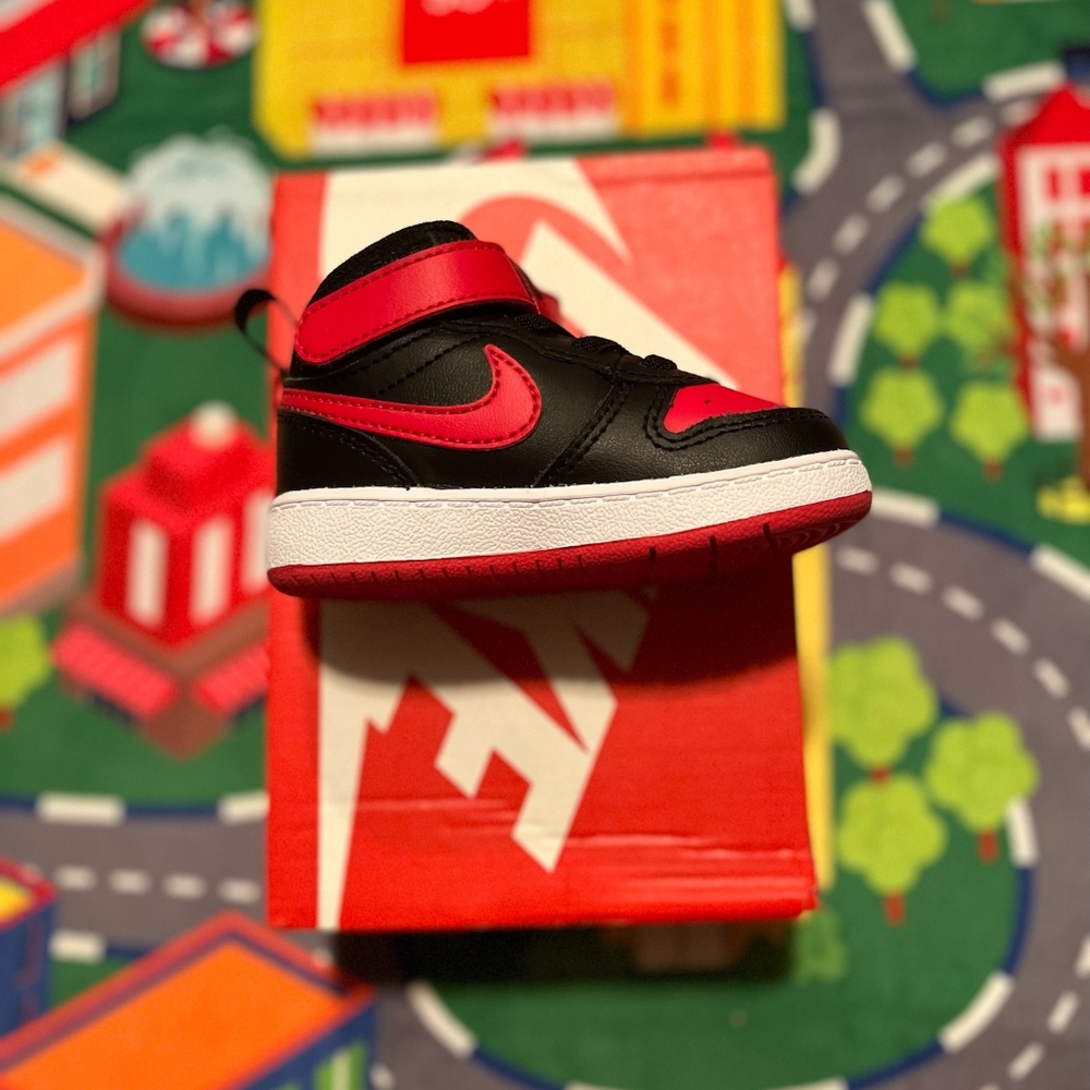 Nike infant shoes size 5 in the color black/university red and white.